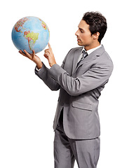 Image showing Business man on globe, choice to travel or worldwide destination isolated onwhite studio background. Vacation, professional suit and agent pointing at earth map for geography or international journey