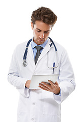 Image showing Man, doctor and tablet in studio for healthcare research, online planning or telehealth schedule. Professional medical worker typing, scroll or reading for digital tech for email on white background