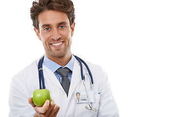 Image showing Portrait, smile and apple with a man doctor in studio isolated on a white background for diet or nutrition. Food, healthcare or medical and a happy young medicine professional with a green fruit