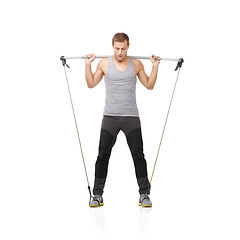 Image showing Gym, workout and resistance band with a young man in studio isolated on a white background for health. Fitness, exercise or performance and a strong athlete training with equipment for wellness