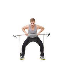 Image showing Fitness, workout and resistance band with a strong man in studio isolated on a white background for health. Gym, exercise or performance and a young athlete training with equipment for wellness