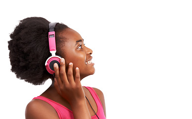 Image showing Headphones, happy and young black girl in a studio listening to music, album or playlist. Smile, teenager and gen z African child model streaming a podcast, song or radio by white background.