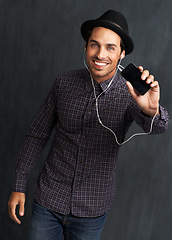 Image showing Fashion, music and portrait of man on gray background with trendy style, clothes and casual outfit. Smile, handsome and face of person with cellphone for listening to audio, radio and song playlist