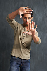 Image showing Hands, selfie frame and portrait of man in studio for photography against grey background. Finger, border and face of male model with social media, profile picture and memory or screenshot gesture
