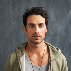 Image showing Fashion, serious and portrait of man on gray background with trendy style, clothes and casual outfit. Attractive, handsome and face of person with confidence, pride and facial expression in studio