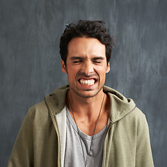 Image showing Funny, face and man in studio with crazy, gesture or facial expression against grey background. Joke, eyes closed and male model with goofy personality, good mood or silly, comic or unique humor