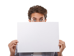 Image showing Portrait, surprise and man hide on poster, sign and advertising on mockup space isolated on white studio background. Face, shock and peeking on paper banner, sales promo or blank placard presentation