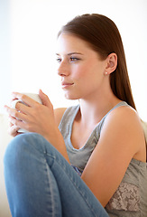 Image showing Home, thinking and woman with peace, coffee cup and relax with ideas, wellness and calm in a living room. Apartment, girl and person on a sofa, tea and decision with a choice, daydreaming and wonder