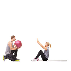 Image showing Coaching, man and woman with gym ball for fitness in studio, body wellness and support. Sports workout, girl and personal trainer with sphere for balance, mat training and power on white background.