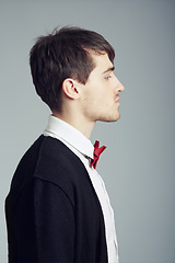 Image showing Profile, business and fashion with man, thinking and confident guy on grey studio background. Person, entrepreneur or model with stylish outfit, elegant clothes or worker with professional or bow tie