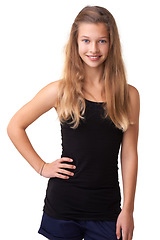 Image showing Portrait, smile and teen children for fashion with a blonde girl in studio isolated on a white background. Model, trendy or style and a happy young kid looking confident in a casual clothing outfit