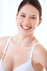 Image showing Underwear, bra and happy portrait of woman with confidence in boobs in studio or white background. Sexy, lingerie and model with a smile for body positivity, fashion and self love in brassiere