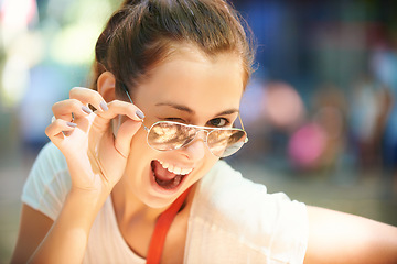 Image showing Woman, portrait and sunglasses for outdoor wink fun at summer festival in nature for camping, social gathering or explore holiday. Female person, face and eyewear for sunny, travel or happy adventure