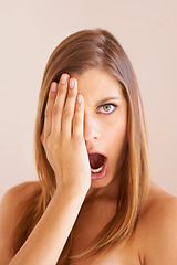 Image showing Cover eye, portrait and surprise with woman, news and gossip on a beige background. Face, person and model with gossip, cosmetics or shock with announcement, facial expression and beauty with makeup