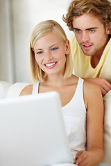 Image showing Happy, laptop and young couple on sofa browsing on social media or the internet at apartment. Smile, technology and man and woman relax and researching on website with computer in living room at home