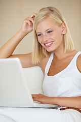 Image showing Laptop, relax and happy woman on a sofa with social media, streaming or website scroll in her home. Tech, movies and female person online in living room chilling with subscription service in a house