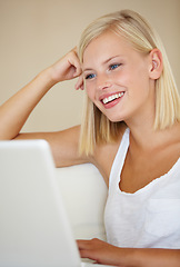 Image showing Relax, laptop and happy woman on a sofa with social media, streaming or website scroll in her home. Tech, movies and female person online in living room chilling with subscription service in a house