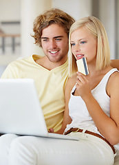 Image showing Couple, credit card and thinking on laptop for online shopping, loan choice or digital money on sofa at home. Young woman and man on computer for internet banking, website payment or e commerce ideas