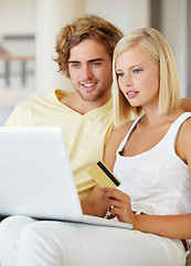 Image showing Couple, credit card and laptop for online shopping, loan registration or digital money on sofa at home. Young woman and man relax on computer for internet banking, website payment or e commerce order