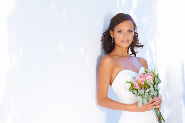 Image showing Happy, wedding and bouquet with portrait of bride at venue for love, celebration and engagement. Ceremony, reception and fashion with woman and flowers in dress for event, commitment and marriage