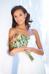 Image showing Makeup, wedding and bouquet with portrait of woman at venue for love, celebration and engagement. Ceremony, reception and fashion with bride and flowers in dress for event, commitment and marriage