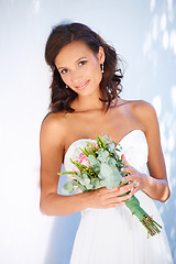 Image showing Young, wedding and bouquet with portrait of woman at venue for love, celebration and engagement. Ceremony, reception and fashion with bride and flowers in dress for event, commitment and marriage