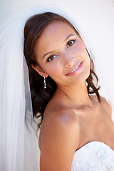 Image showing Portrait, smile and a woman at her wedding for love, marriage or an event of tradition in celebration of commitment. Face, beauty and elegance with a happy young bride getting married at a ceremony