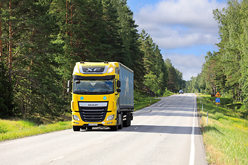 Image showing Yellow DAF XF Truck Delivers Goods on Sunny Summer Morning