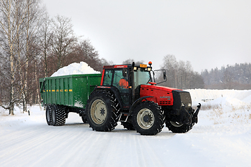 Image showing Red Tractor Transports Snow to Snow Dump