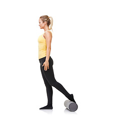 Image showing Studio, foam roller and woman exercise for leg strength challenge, tension relief or rehabilitation fitness. Pilates workout, mockup space and person training for body wellness on white background