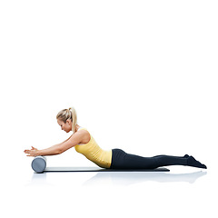 Image showing Pilates, foam roller and woman in a studio for workout, stretching or gym routine with yoga mat. Stability, balance and young female athlete from Australia with body exercise by white background.