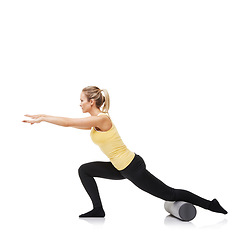 Image showing Workout, foam roller and woman with legs exercise, lunge or balance for endurance challenge, gym club performance or stretching. Pilates, fitness studio or female athlete training on white background