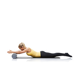 Image showing Fitness, foam roller and woman in a studio for exercise, stretching or gym routine with yoga mat. Stability, balance and young female athlete from Australia with body workout by white background.