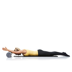 Image showing Studio pilates, foam roller and fitness woman in floor exercise, stretching or sports wellness for core strength. Ground, mockup space and athlete equipment for workout support on white background