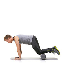 Image showing Pilates, foam roller and man in a studio for exercise, stretching or gym routine with yoga mat. Stability, balance and young male athlete from Australia with body workout by white background.