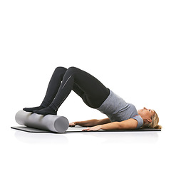 Image showing Core exercise, foam roller and studio woman with bridge workout, balance activity or wellness for gym pilates on floor. Fitness, mockup space and girl body development on yoga mat on white background