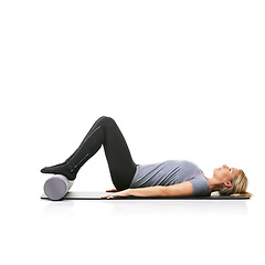Image showing Floor exercise, foam roller and studio woman workout for active lifestyle, gym pilates and rest after fitness routine. Ground, mockup space and girl body development on yoga mat on white background