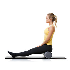 Image showing Woman, foam and roller on mat for yoga, exercise or fitness workout in studio on white background. Pilates, profile or healthy lady balance on rolling tube for training, strong core or massage muscle