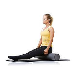 Image showing Studio workout, foam roller and woman with posture exercise, spine rehabilitation or yoga performance challenge. Floor, body wellness training and person sit on fitness equipment on white background
