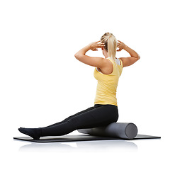 Image showing Yoga fitness, foam roller and person stretching back for spine posture training, wellness challenge or active performance. Studio floor, exercise mat and athlete physical activity on white background