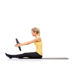 Image showing Woman, pilates ring and arms for stretching exercise on yoga mat or resistance healthy, roll up or studio white background. Female person, equipment for muscle flexibility, wellness balance or mockup