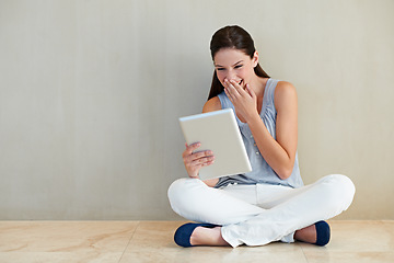 Image showing Happy woman, tablet and laughing for funny joke, social media or meme sitting on floor at home. Female person, brunette or freelancer smile and giggling with technology for humor or comedy on mockup