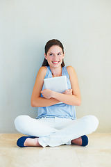 Image showing Happy woman, tablet and sitting on floor for business, social media or communication at home. Young female person or freelancer smile against wall with technology for online networking at house