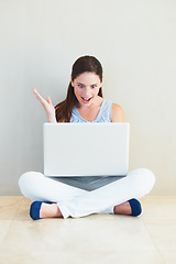 Image showing Surprise, woman and laptop on floor for good news, social media or winning prize at home. Shocked female person or freelancer in wow on computer for notification, deal or alert against wall at house