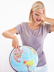 Image showing Wow, guess or pointing and a woman with a globe in studio on a white background for destination choice. World, planet and hand gesture to a location on earth for overseas travel decision or selection