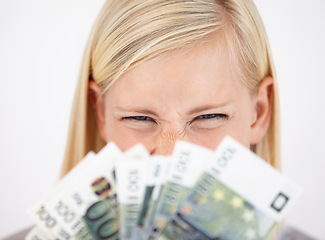 Image showing Money, finance and lottery winner with a woman closeup in studio on a white background for profit or increase. Eyes, economy or investment and an excited young person with cash for financial freedom