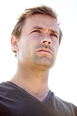 Image showing Thinking, serious and young man in a studio with brainstorming, ideas or planning facial expression. Handsome, confident and male person from Canada with wonder or dreaming face by white background.