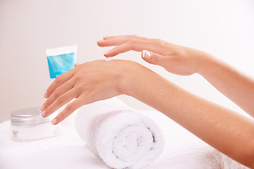 Image showing Skincare, lotion and hands closeup in spa, touch and massage for wellness. Fingers, nails and woman apply cream in treatment, natural cosmetics or dermatology moisturizer, beauty health or manicure