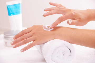 Image showing Skincare, cream and hands closeup in spa, touch and massage on towel. Fingers, nails and woman apply lotion in treatment, natural cosmetics and dermatology moisturizer, beauty health and manicure