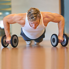 Image showing Man, gym and pushup on floor, dumbbells or workout for muscle development, growth and results for health. Person, exercise and bodybuilder with training process, strong arms and progress for wellness